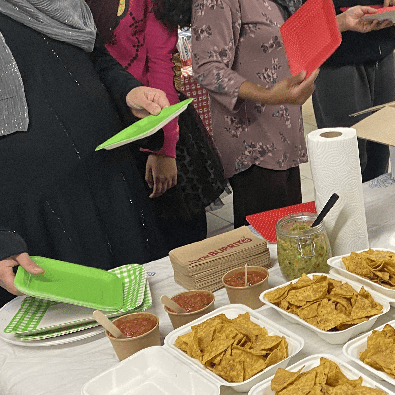 People gathered around table with food