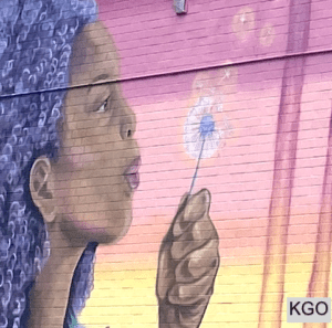 mural detail of woman blowing dandelion