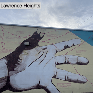 Painting of a hand on Lawrence Heights mural
